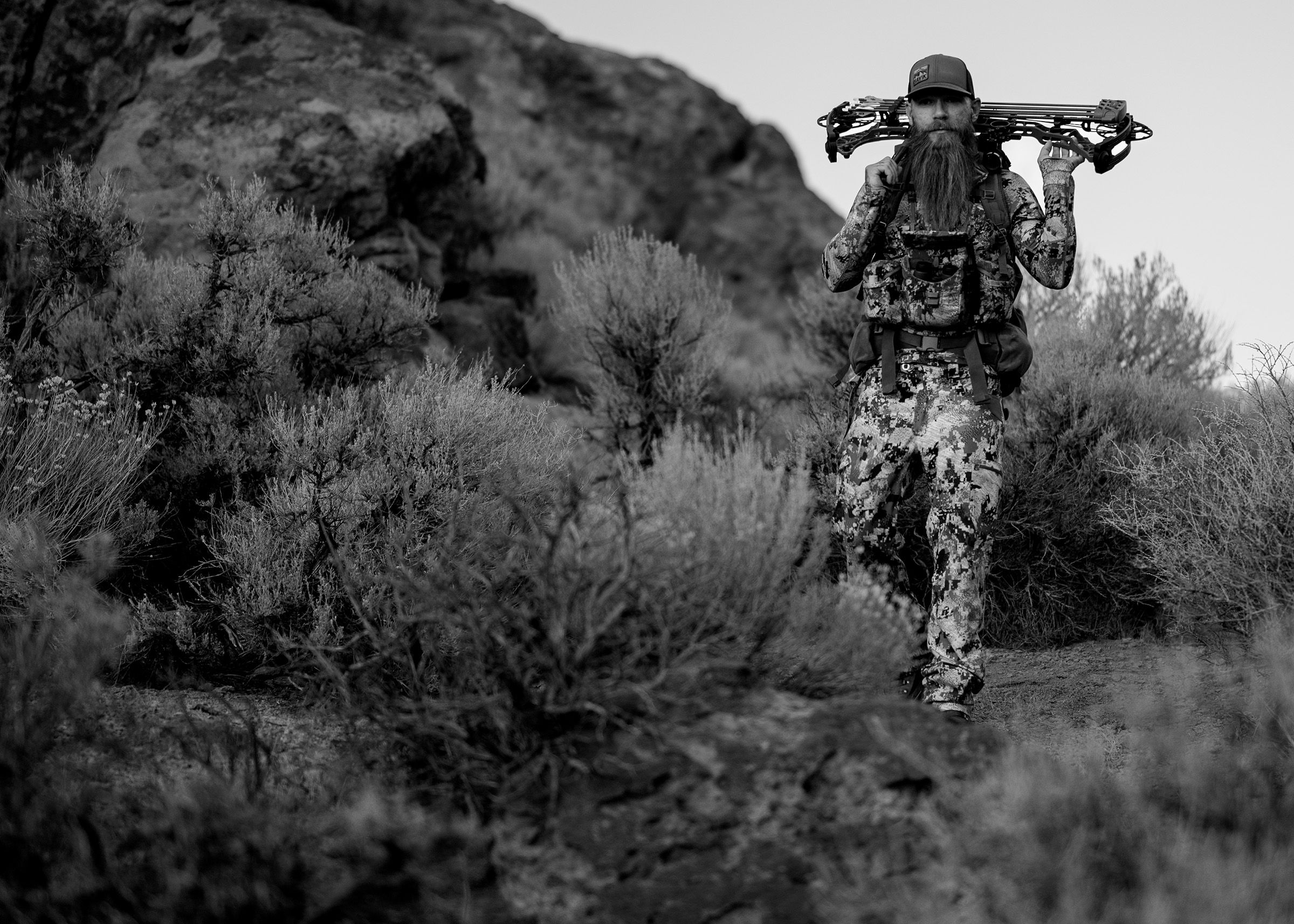 Bowhunter in sage and rocks, central Nevada