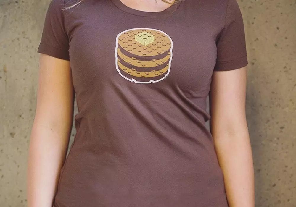 Person wearing a t-shirt with a LEGO-style ShortStack pancake logo